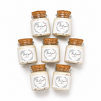 Mini candle favours displayed together in glass jars